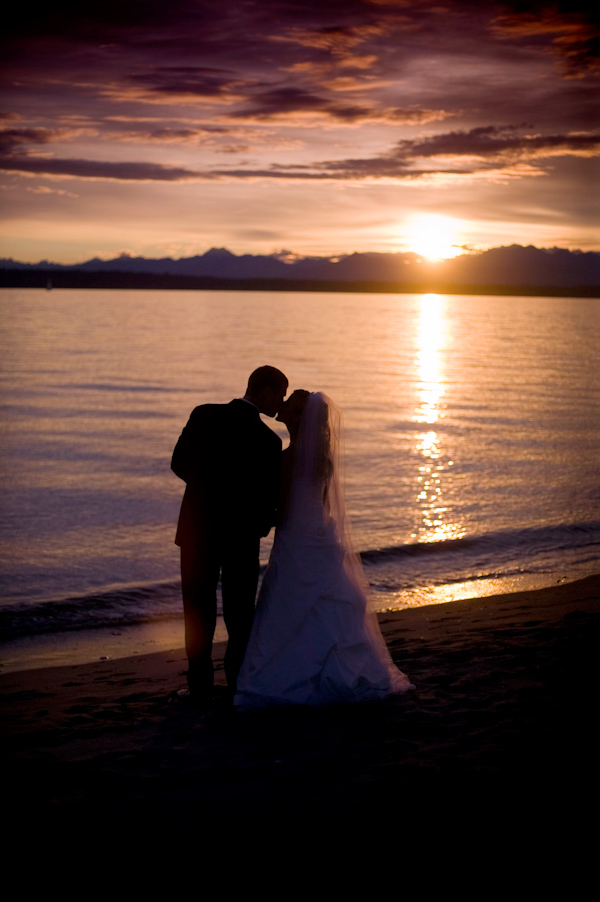 Bride and groom kiss on the beach at sunset - wedding photo by J Garner Photographer